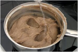 adding hot water to amala fele fele
