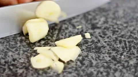 slicing frozen garlic cloves